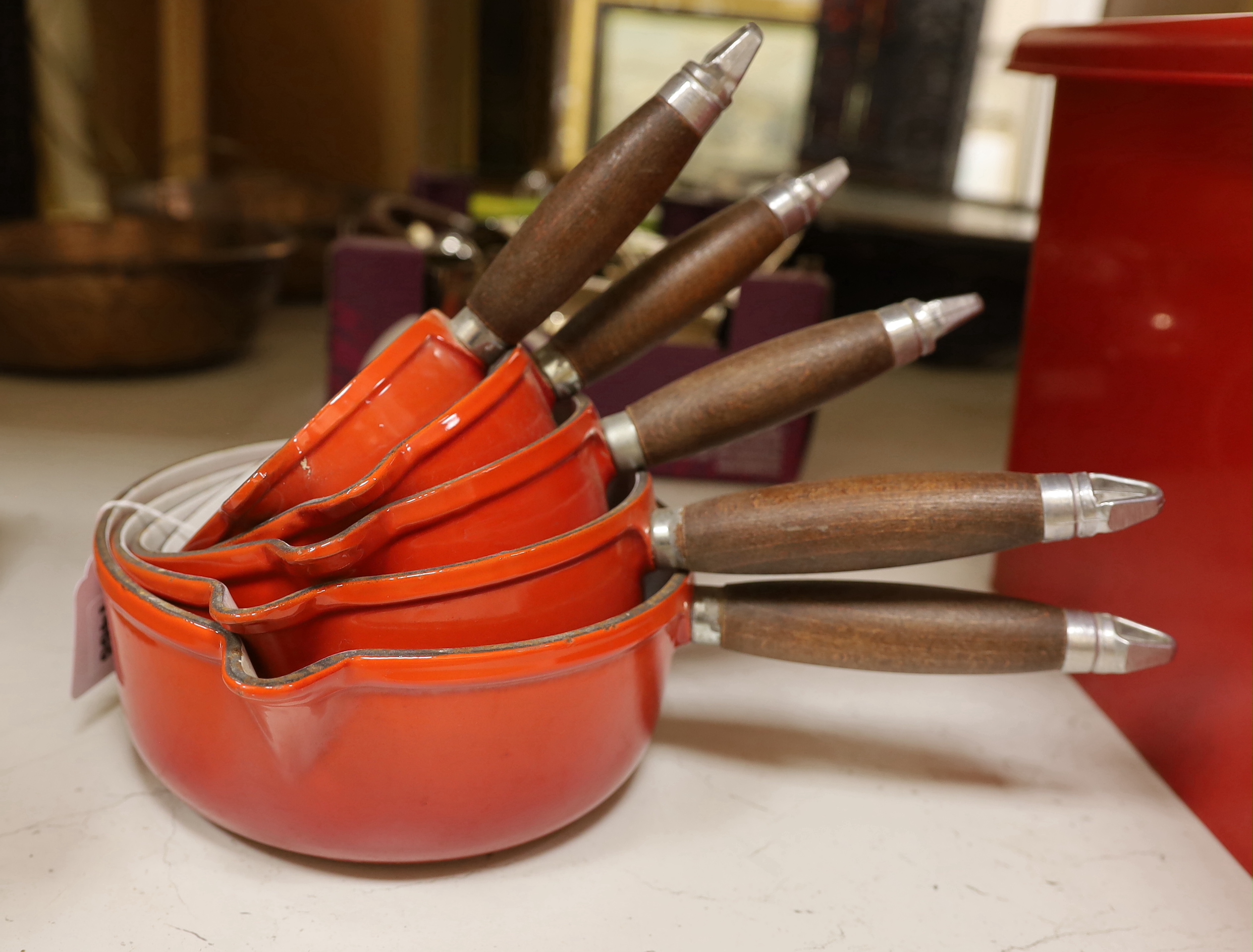 Five graduated Nomar French enamel saucepans